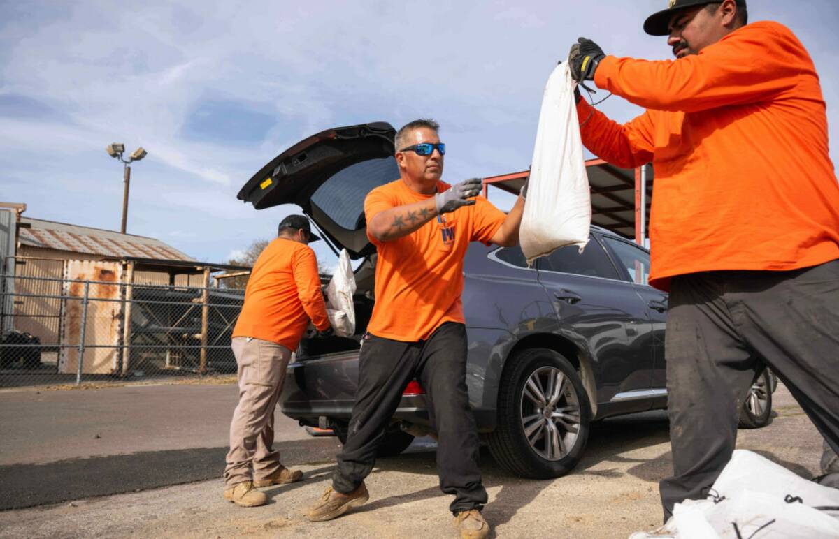 Los Angeles County Public Works crew loads sandbags for residents on Monday, December 22, 2025 ...