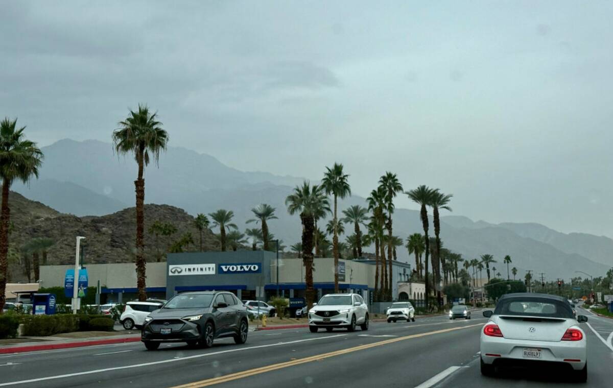 Drivers make their way in the rain on East Palm Canyon Drive, Tuesday, Dec. 23, 2025, in Palm S ...
