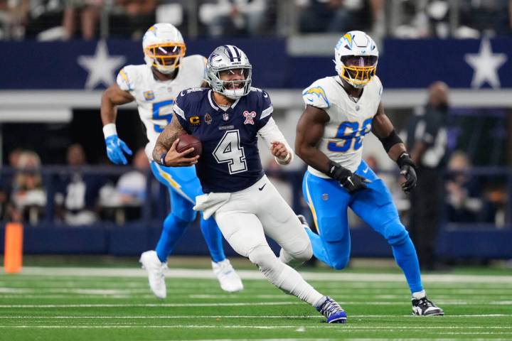 Dallas Cowboys quarterback Dak Prescott (4) runs during the second half of an NFL football game ...