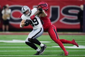Las Vegas Raiders tight end Brock Bowers (89) runs against Houston Texans safety Jalen Pitre du ...