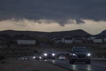 Clouds and scattered rain pass over drivers on West Ann Road near Tropical Parkway on Wednesday ...