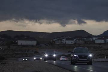 Clouds and scattered rain pass over drivers on West Ann Road near Tropical Parkway on Wednesday ...