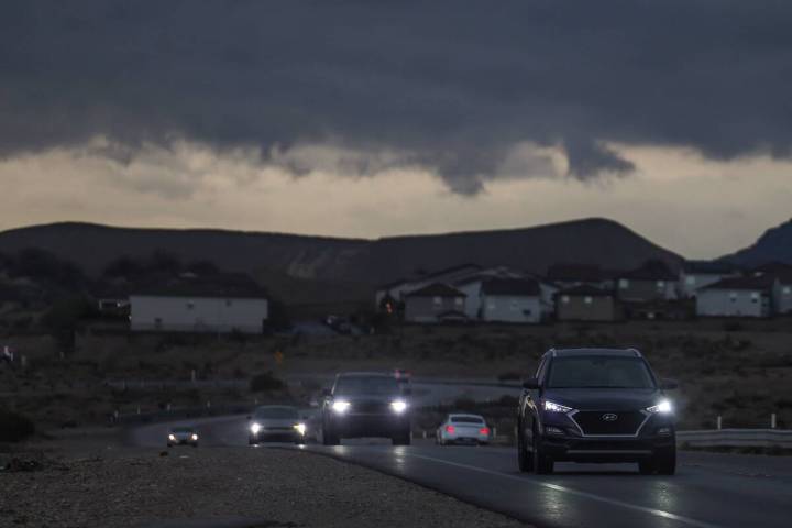 Clouds and scattered rain pass over drivers on West Ann Road near Tropical Parkway on Wednesday ...