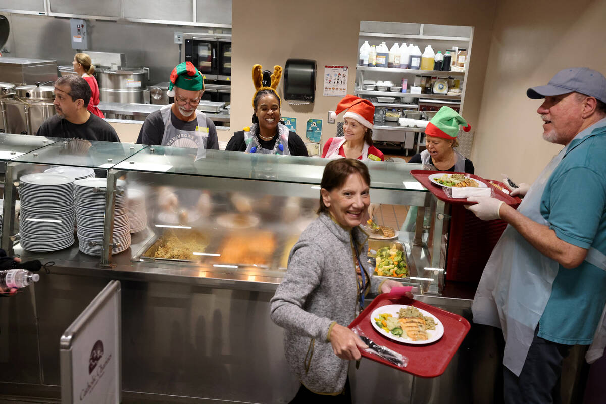 Volunteers serve Christmas meals at Catholic Charities of Southern Nevada in Las Vegas Thursday ...
