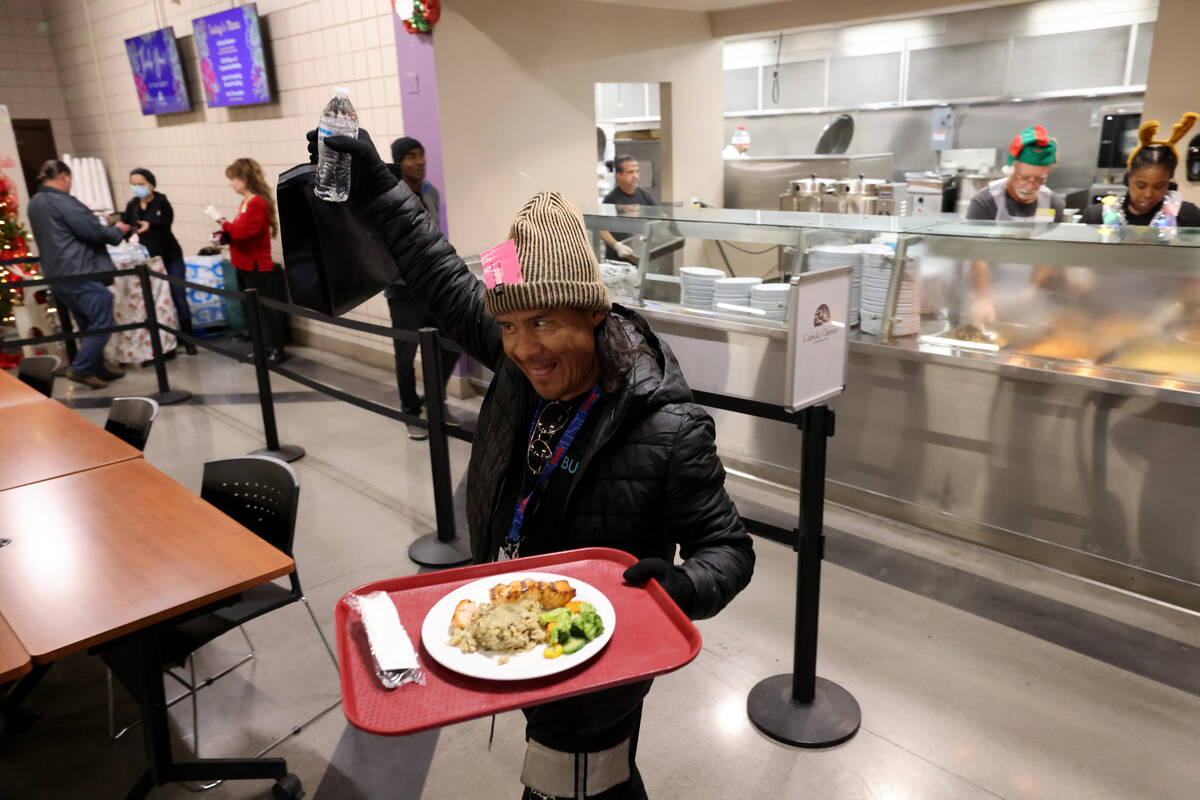 A guest grabs a Christmas meal at Catholic Charities of Southern Nevada in Las Vegas Thursday, ...