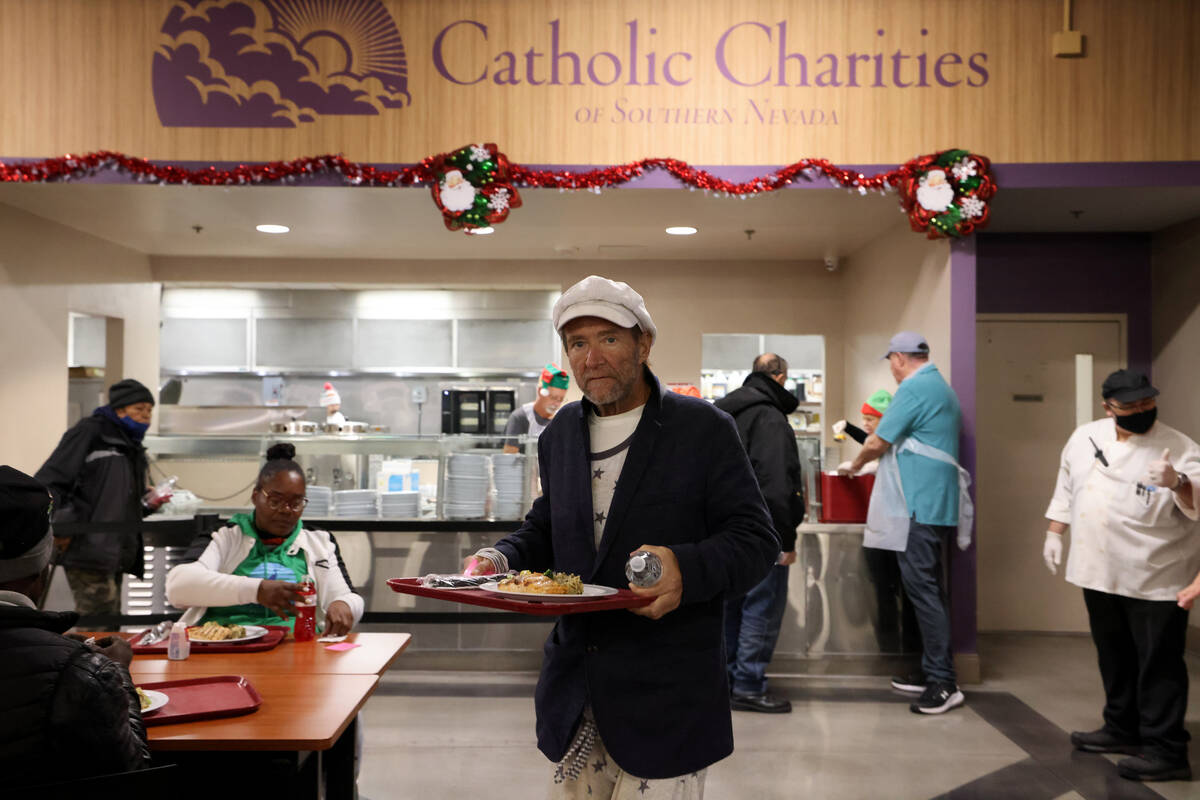 A guest grabs a Christmas meal at Catholic Charities of Southern Nevada in Las Vegas Thursday, ...