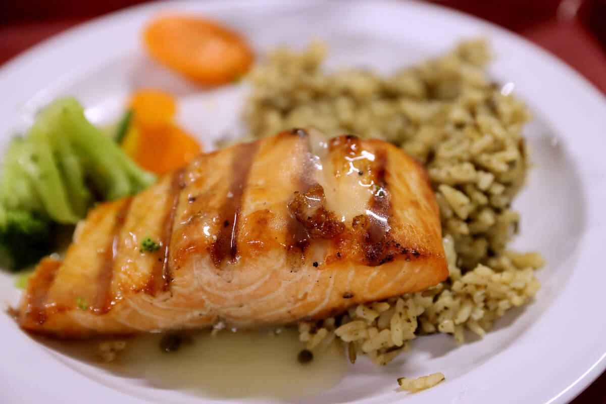 A Christmas meal crafted by Chef Jun Lao features freshly prepared grilled salmon with bright l ...