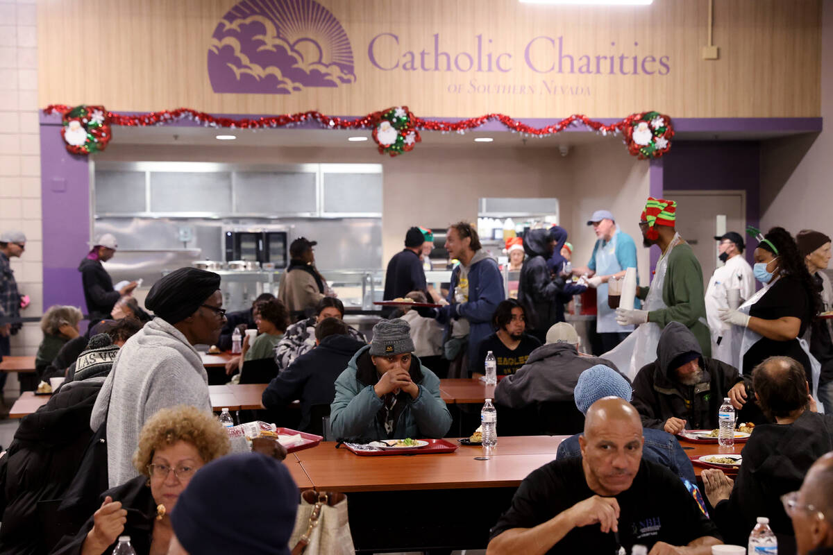Guests eat Christmas meals at Catholic Charities of Southern Nevada in Las Vegas Thursday, Dec. ...