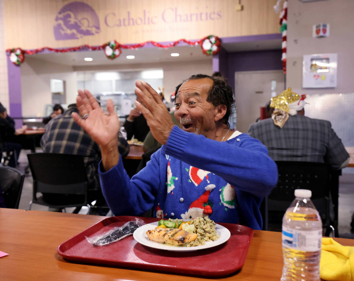 Keath Harris, 63, reacts to seeing dessert coming his way during a Christmas meal at Catholic C ...