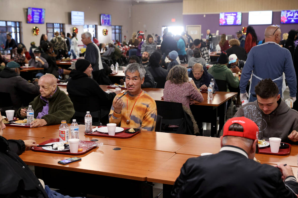 Guests eat Christmas meals at Catholic Charities of Southern Nevada in Las Vegas Thursday, Dec. ...