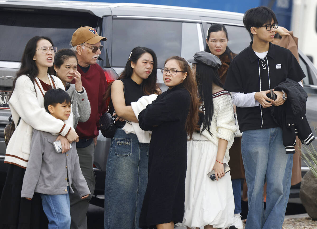 People watch as Clark County and North Las Vegas firefighters are battling a fire that erupted ...