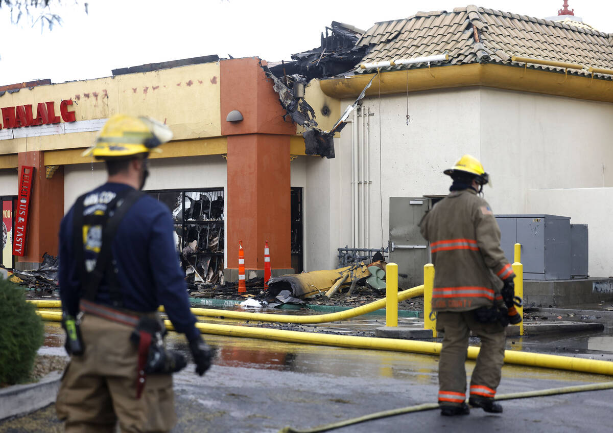 Clark County and North Las Vegas firefighters are battling a fire that erupted from a building ...