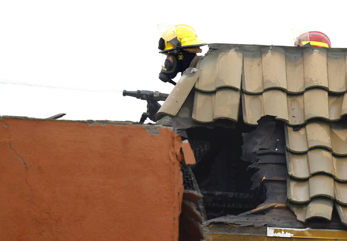 Clark County and North Las Vegas firefighters are battling a fire erupted from a building in th ...