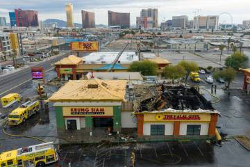 Clark County and North Las Vegas firefighters are battling a fire that erupted from a building ...