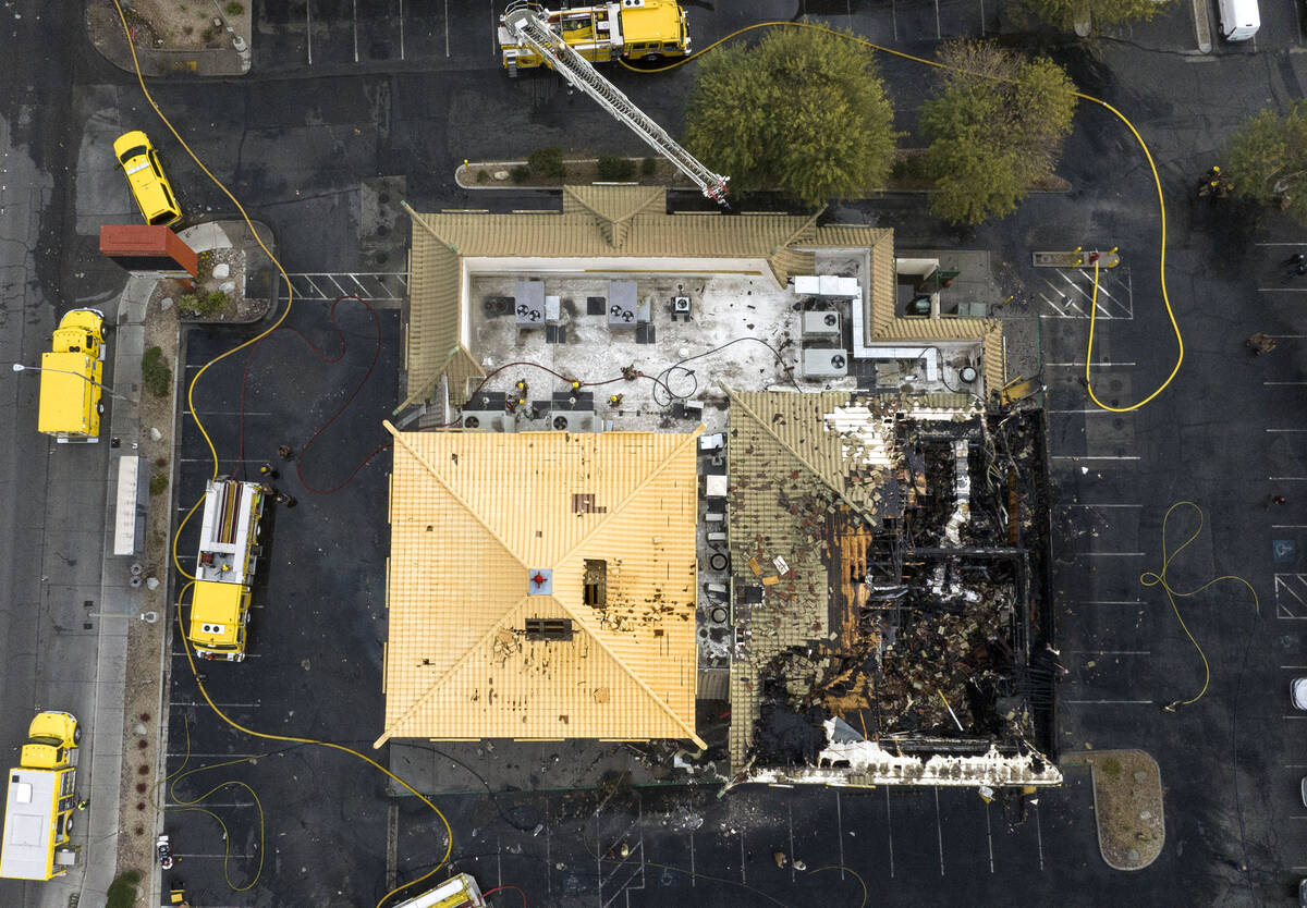 Clark County and North Las Vegas firefighters are battling a fire that erupted from a building ...