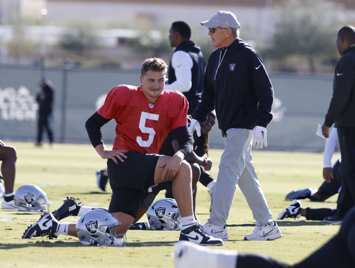 Raiders head coach Pete Carroll walks through the team’s practice as quarterback Cam Mil ...