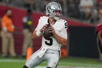Las Vegas Raiders quarterback Cam Miller (5) looks to throw agaisnt the Arizona Cardinals durin ...