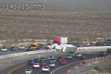 A semi-tractor trailer is on its side Saturday, Dec. 27, 2025, on southbound Interstate 15 at m ...