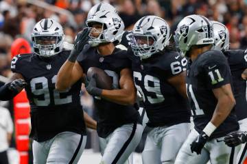 Raiders defensive end Charles Snowden (49) celebrates his interception with teammates during th ...
