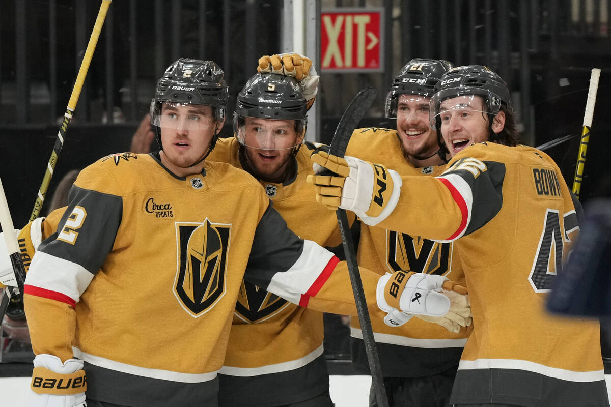 Vegas Golden Knights center Brett Howden, second from right, celebrates his goal with defensema ...