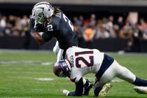 Denver Broncos cornerback Riley Moss (21) tackles Raiders running back Ashton Jeanty (2) during ...