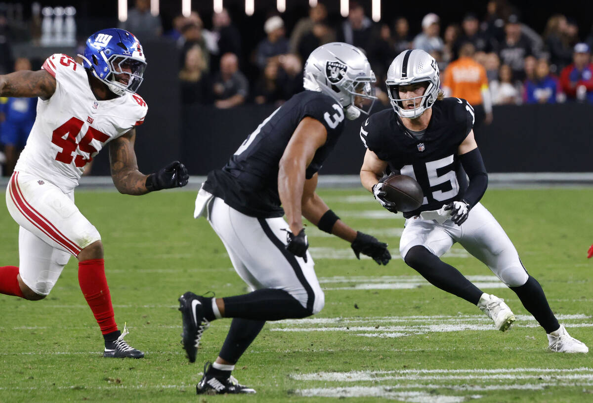 Raiders quarterback Kenny Pickett (15) runs with the ball during the second half of an NFL game ...