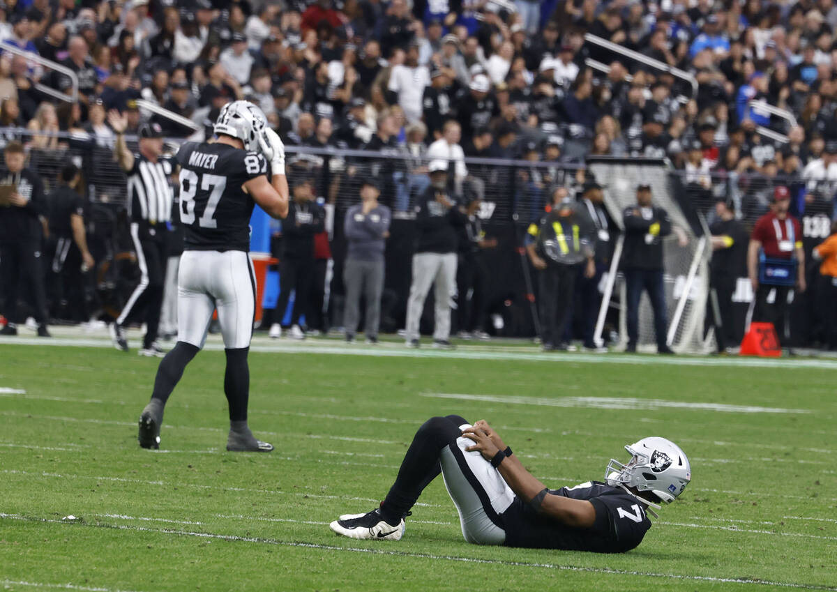 Raiders tight end Michael Mayer (87) reacts as quarterback Geno Smith (7) lies on the ground af ...