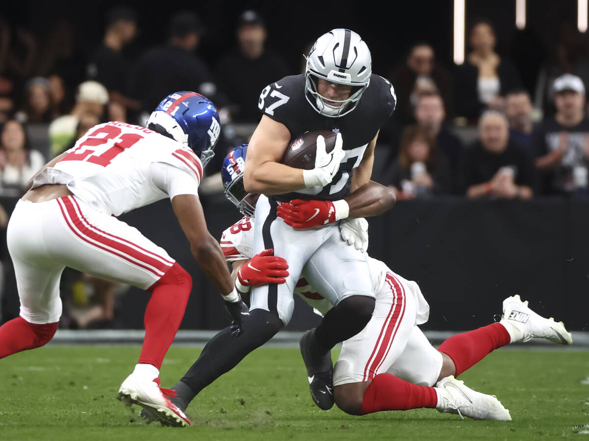 Raiders tight end Michael Mayer (87) gets tackled by New York Giants linebacker Bobby Okereke ( ...
