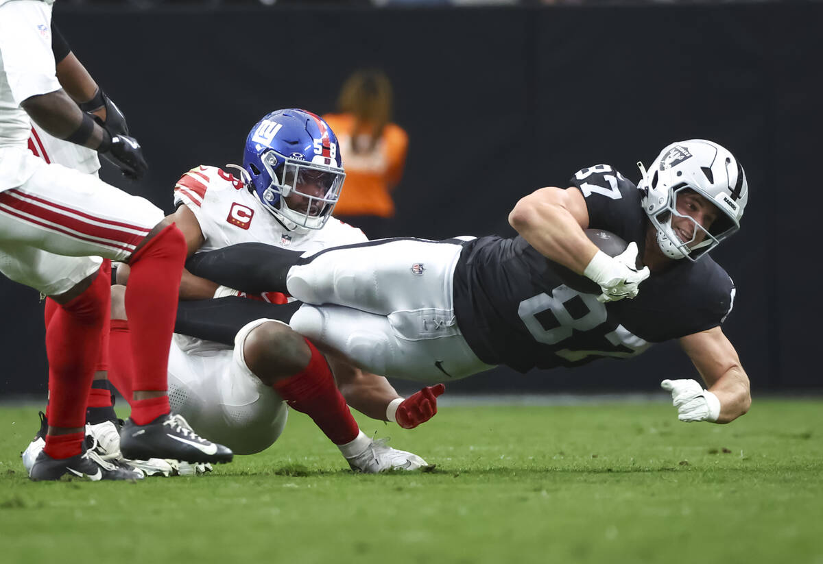 Raiders tight end Michael Mayer (87) gets tackled by New York Giants linebacker Bobby Okereke ( ...