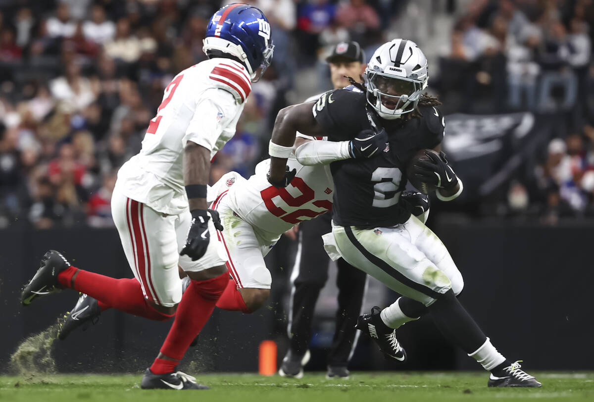 Raiders running back Ashton Jeanty (2) runs the ball as New York Giants cornerback Dru Phillips ...