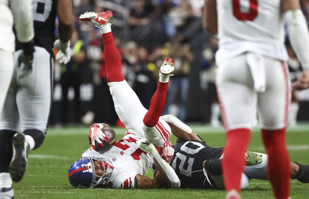 New York Giants wide receiver Wan'Dale Robinson (17) gets tackled by Raiders safety Isaiah ...