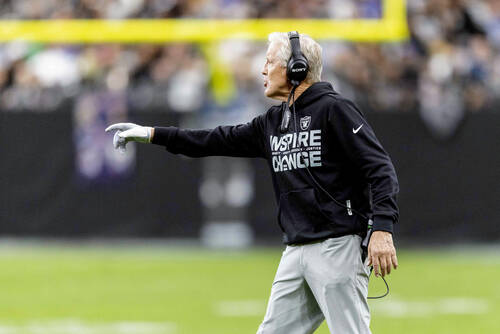 Raiders head coach Pete Carroll points to the field during the first half of an NFL game agains ...