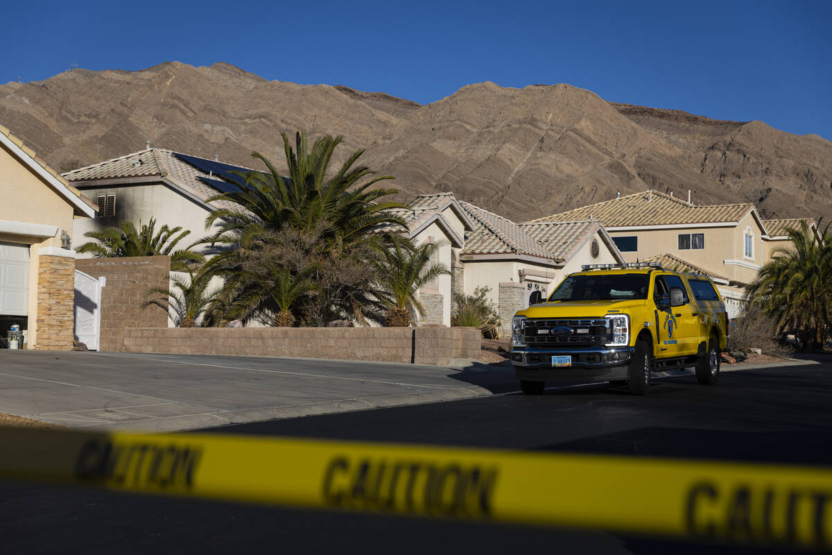 Clark County firefighters investigate the scene of a fire that left one dead at a home at 6900 ...