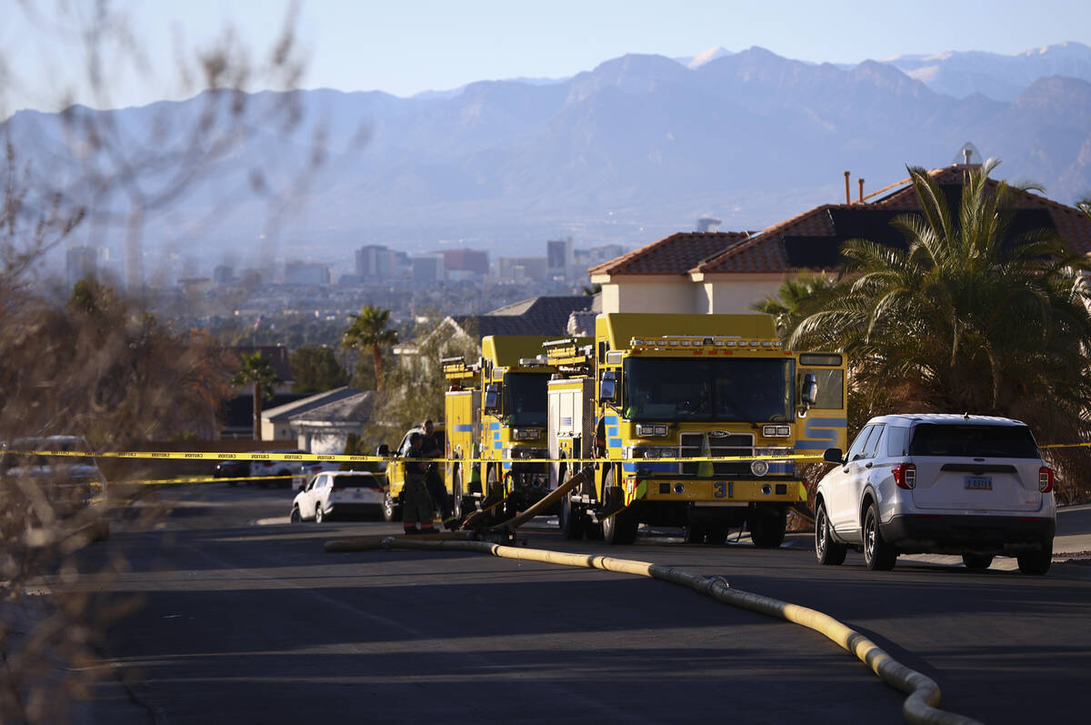 Clark County firefighters investigate the scene of a fire that left one dead at a home at 6900 ...