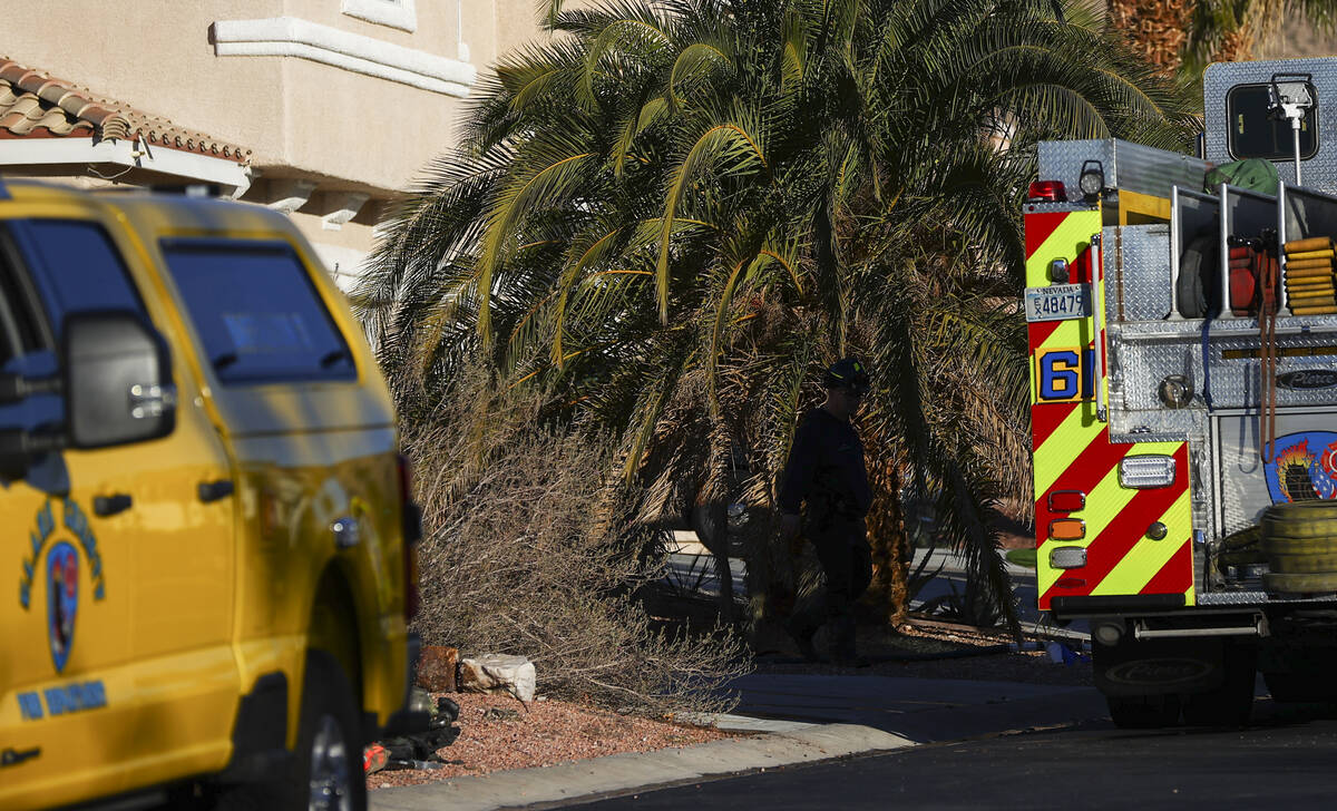 Clark County firefighters investigate the scene of a fire that left one dead at a home at 6900 ...