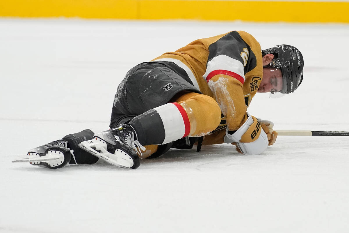 Vegas Golden Knights defenseman Zach Whitecloud (2) lies on the ice during the third period of ...