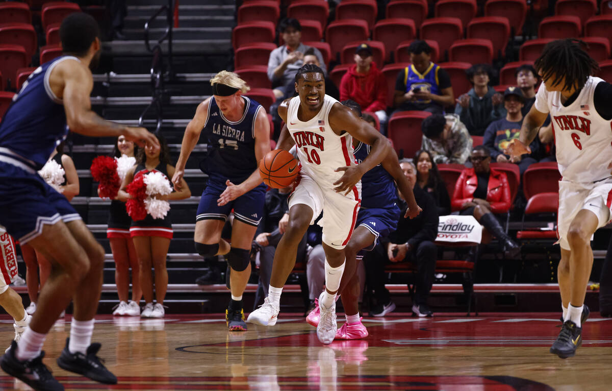 UNLV Rebels forward Jacob Bannarbie (10) brings the ball up court against the La Sierra Golden ...