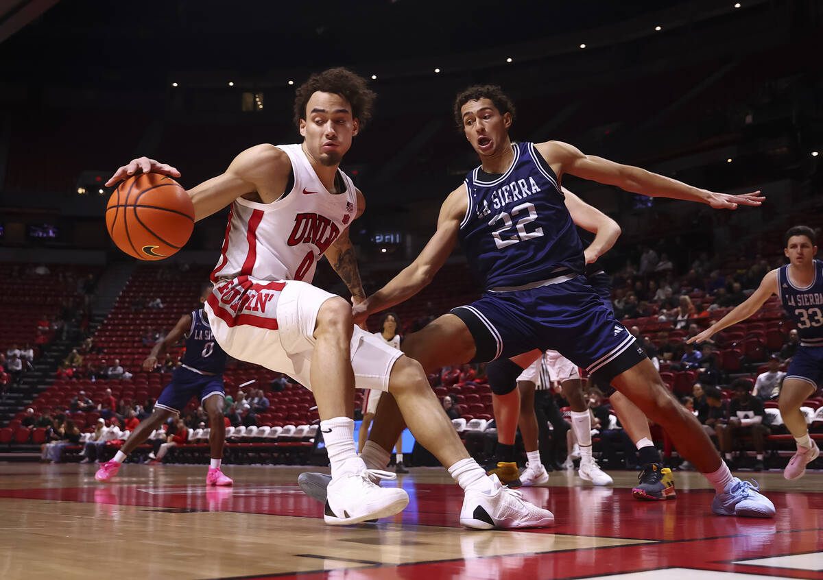 UNLV Rebels guard Dravyn Gibbs-Lawhorn (0) drives the ball under pressure from La Sierra Golden ...