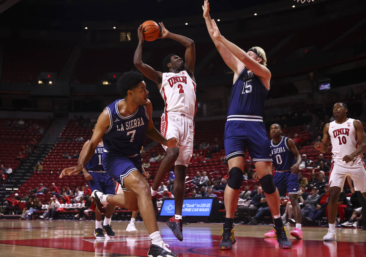UNLV Rebels forward Kimani Hamilton (2) looks to shoot under pressure from La Sierra Golden Eag ...