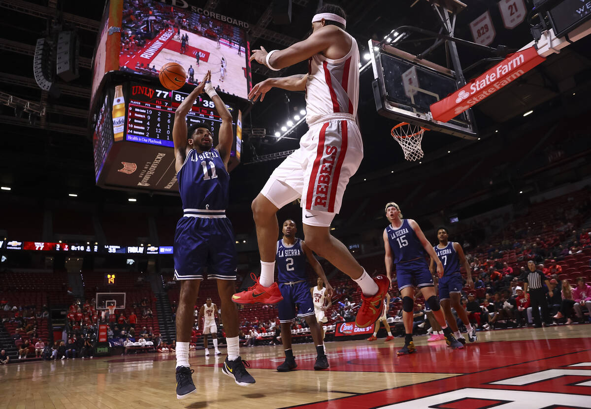 UNLV Rebels guard Howie Fleming Jr. (3) tries to keep the ball in as La Sierra Golden Eagles gu ...