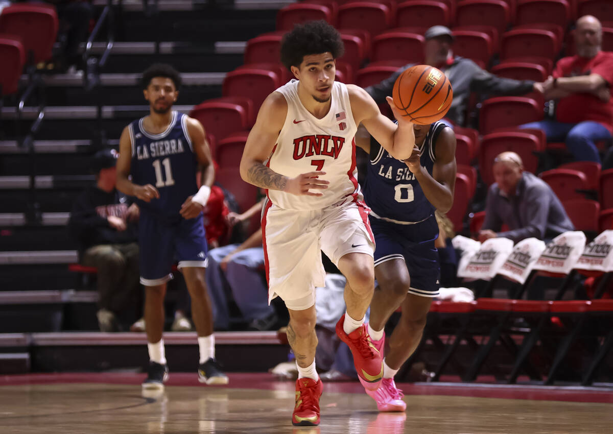 UNLV Rebels guard Al Green (7) brings the ball up court past La Sierra Golden Eagles guard Maka ...