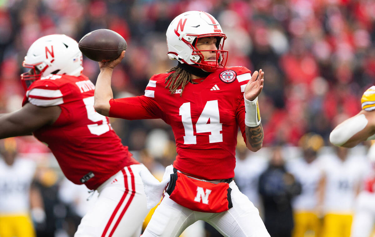 Nebraska quarterback TJ Lateef (14) passes against Iowa during the first half of an NCAA colleg ...
