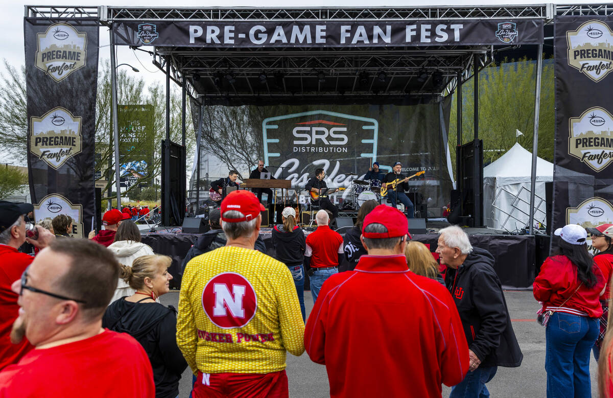 A band performs for Nebraska and Utah fans during the pre-game fan fest before the Las Vegas Bo ...