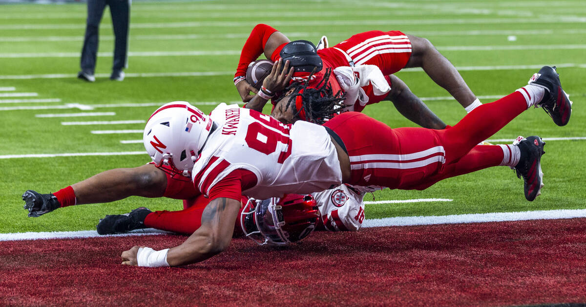 Utah Utes quarterback Devon Dampier (4) goes over Nebraska Cornhuskers defensive lineman Elijah ...
