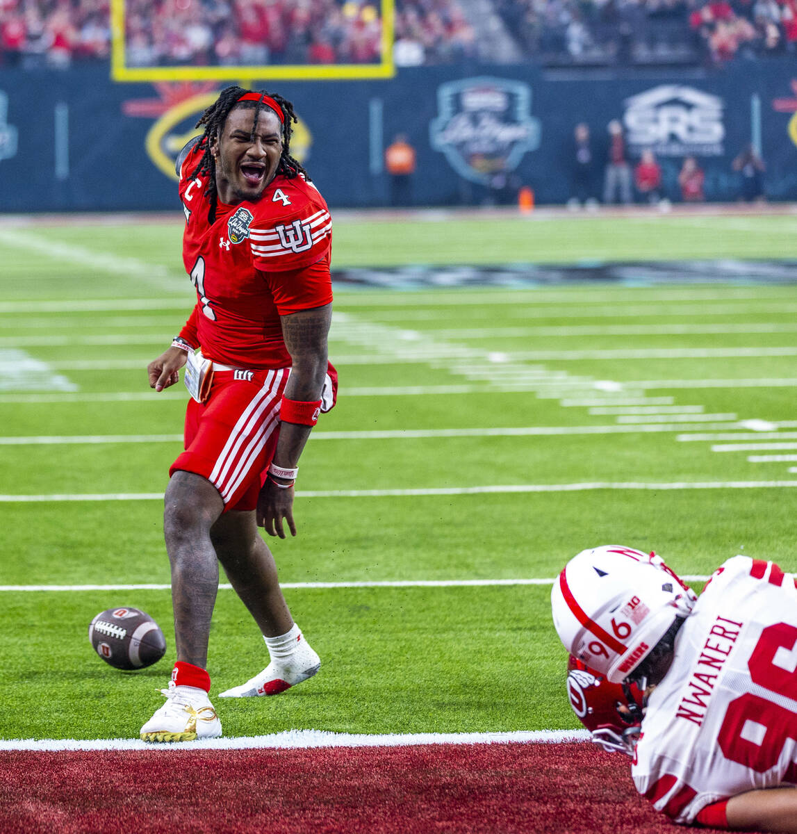 Utah Utes quarterback Devon Dampier (4) loses his helmet while celebrating a score over Nebrask ...