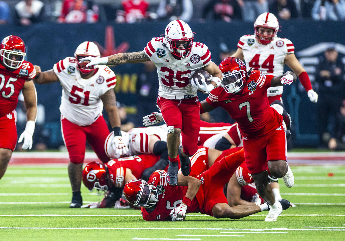 Nebraska Cornhuskers running back Mekhi Nelson (35) leaps past Utah Utes safety Tao Johnson (5) ...