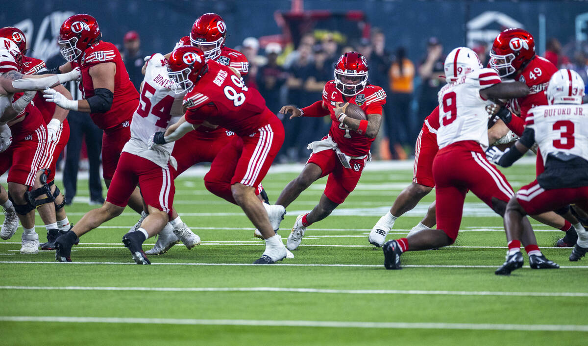 Utah Utes quarterback Devon Dampier (4) breaks through a hole in the line against the Nebraska ...