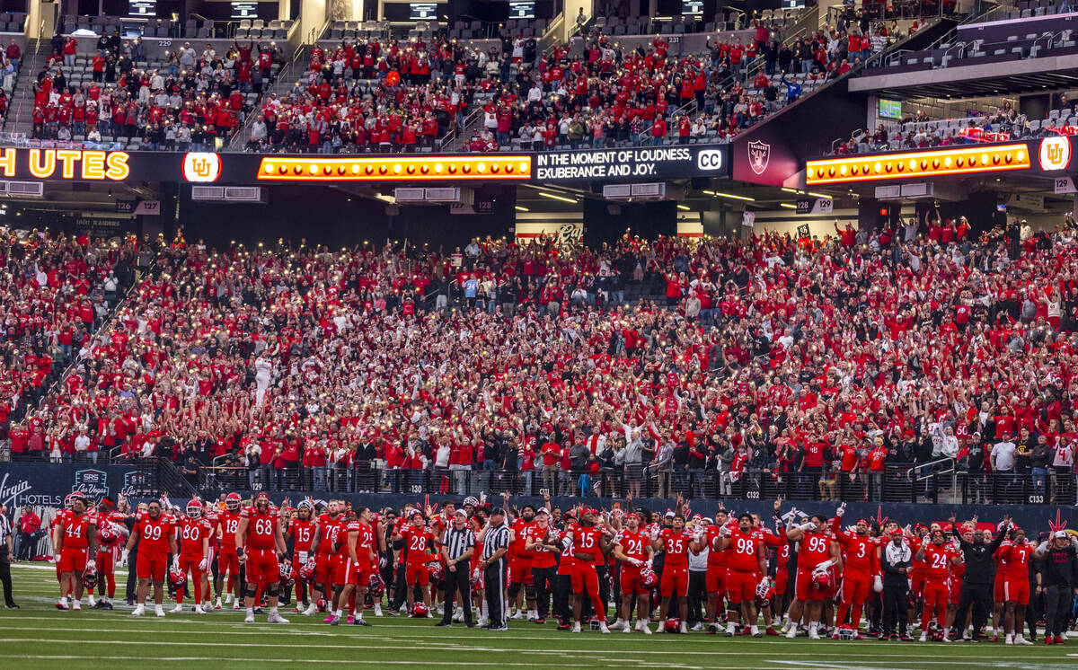 Utah Utes players and coaches join fans to light up the stadium on a timeout against the Nebras ...
