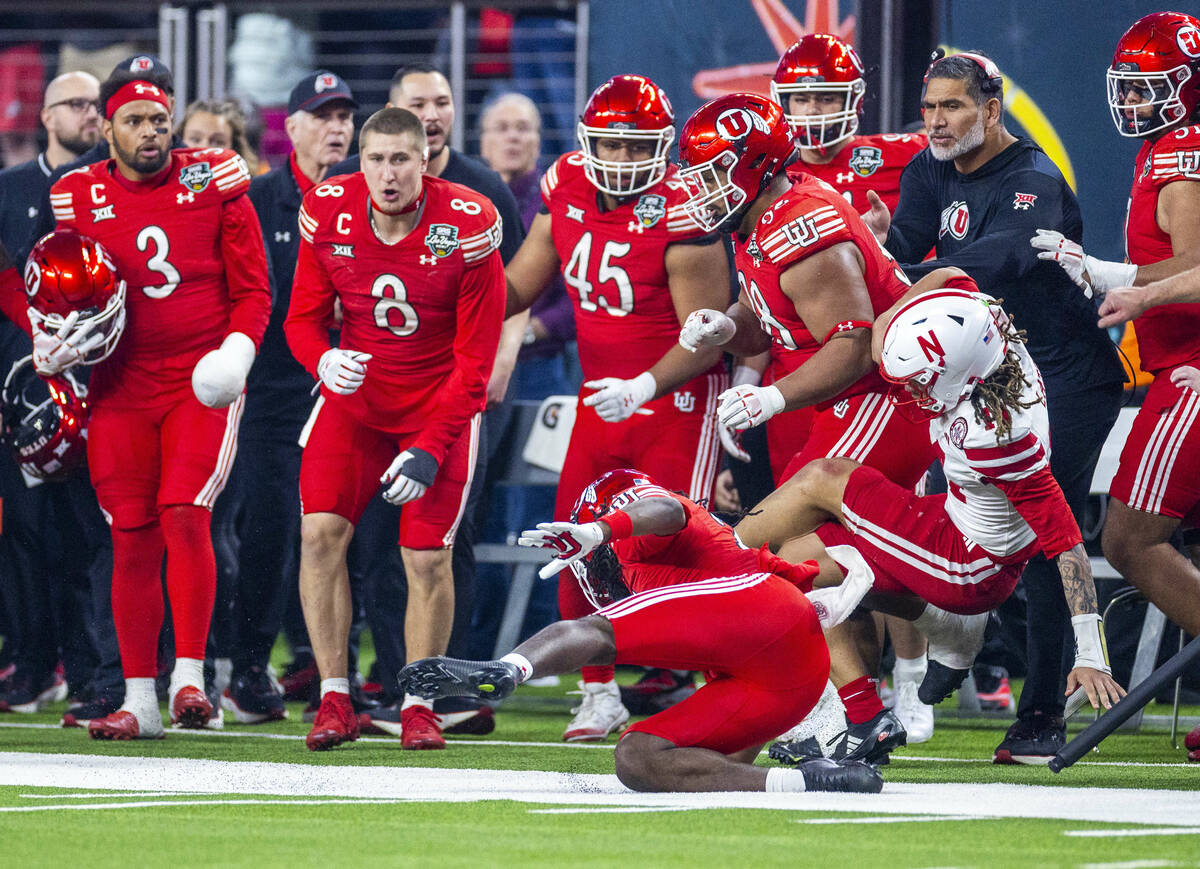 Utah Utes safety Nate Tilmon (21) hits Nebraska Cornhuskers quarterback TJ Lateef (14) out of b ...