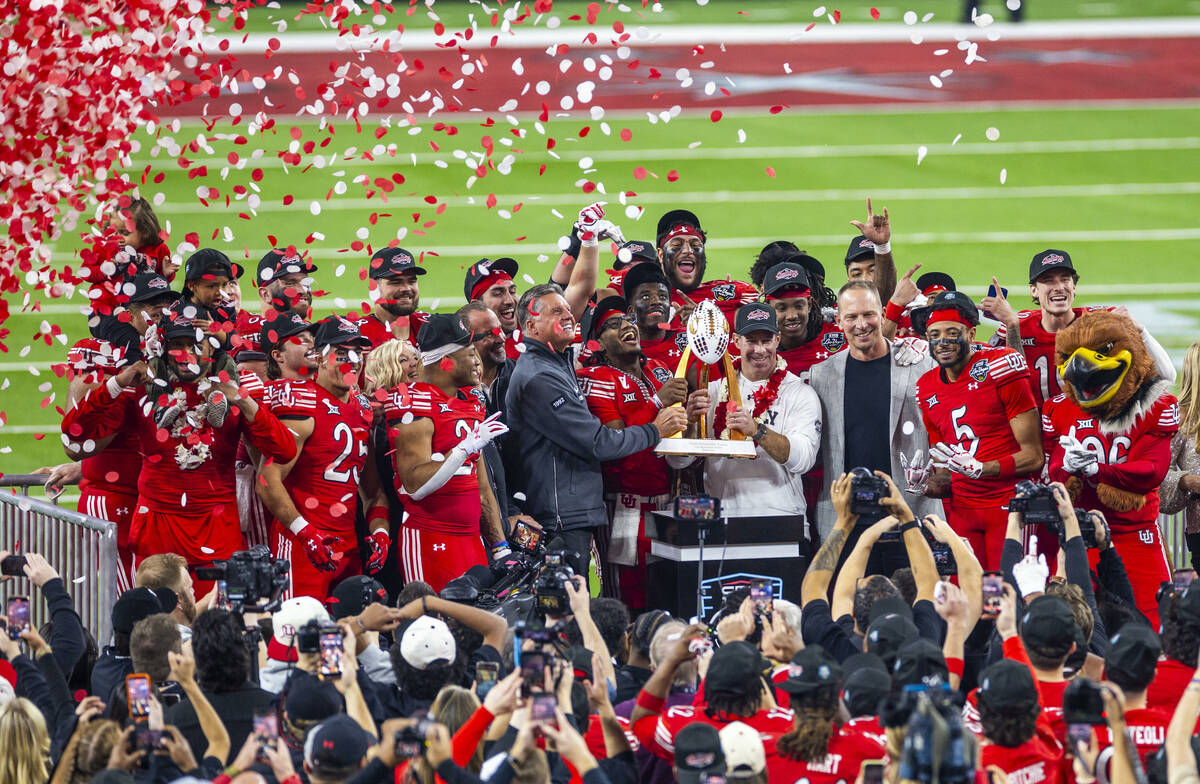 The championship trophy is delivered to the Utah Utes with head coach Morgan Scalley after defe ...